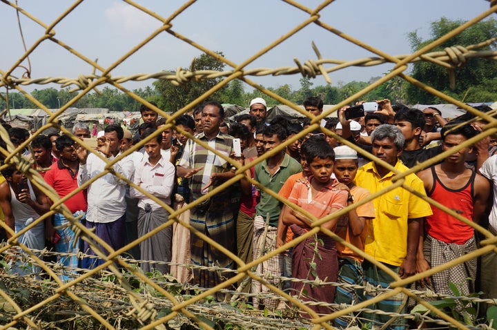 Rohingya Muslims gather behind Myanmar's border lined with barbed wire fences in Maungdaw district, located in Rakhine State bounded by Bangladesh on March 18, 2018.