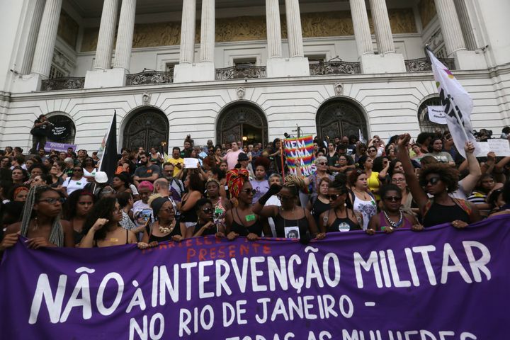 Protesters call for an end to the military intervention in Rio de Janeiro while demonstrating after Franco's murder. 