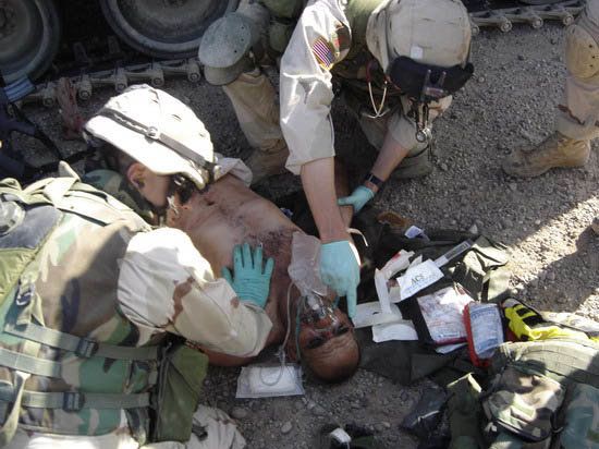 Jason Hartley posted this photo of soldiers helping a wounded Iraqi to his blog. 