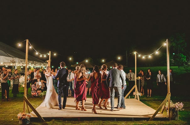 Play your first dance song and invite guests to come up and dance alongside you. 