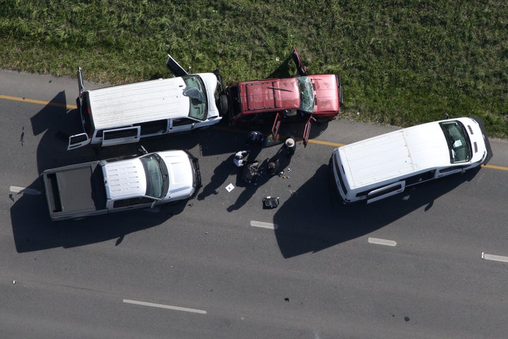 Law enforcement personnel investigate the scene where the Texas bombing suspect blew himself up on the side of a highway north of Austin in Round Rock, Texas, on Wednesday.