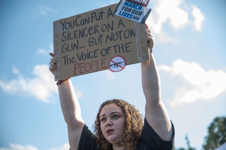 Sophie Phillips holds a sign on March 20 as she attends a rally in Parkland, Florida, for those heading to the March for Our Lives event in Washington, D.C.