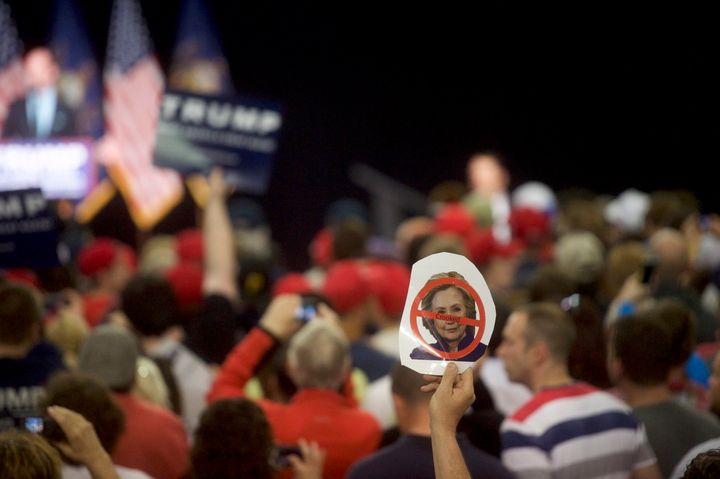 A Donald Trump supporter holds an anti-Hillary Clinton sign during a rally at the Pennsylvania Farm Show Complex & Expo Center on April 21, 2016 in Harrisburg, Pennsylvania.
