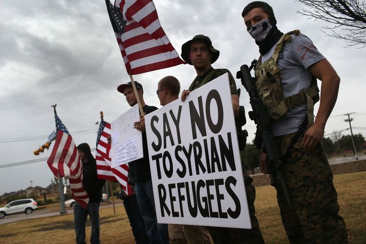 Armed protesters from the so-called Bureau of American-Islamic Relations (BAIR) take part in a demonstration in front of a mosque on Dec. 12, 2015, in Richardson, Texas. 