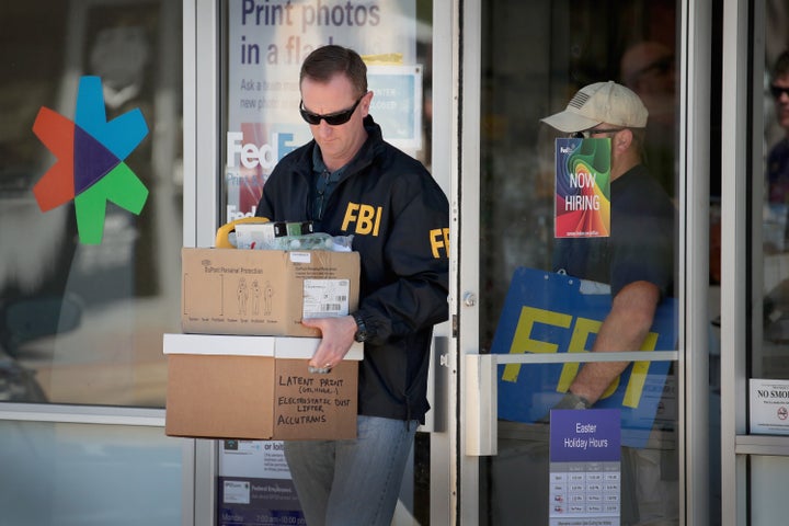 FBI agents collect evidence at a FedEx facility following an explosion at a nearby sorting center on Tuesday in Sunset Valley, Texas. The bomber responsible for several Central Texas explosions was a white Christian man from the area.