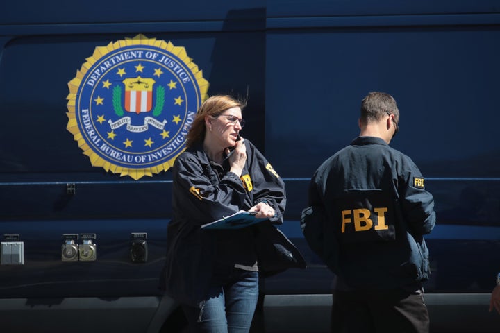 FBI agents collect evidence at a Sunset Valley, Texas, package sorting facility on Tuesday.