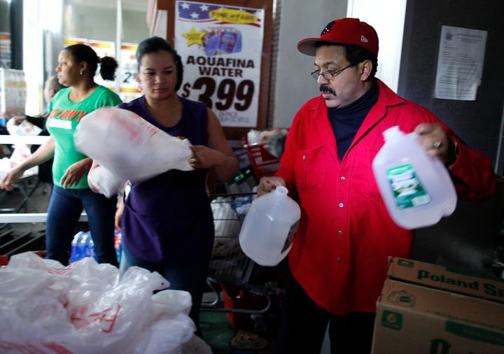 Workers load bottles of water into bags at Fine Fare in lower Manhattan, New York, in the aftermath of Hurricane Sandy in October 2012.