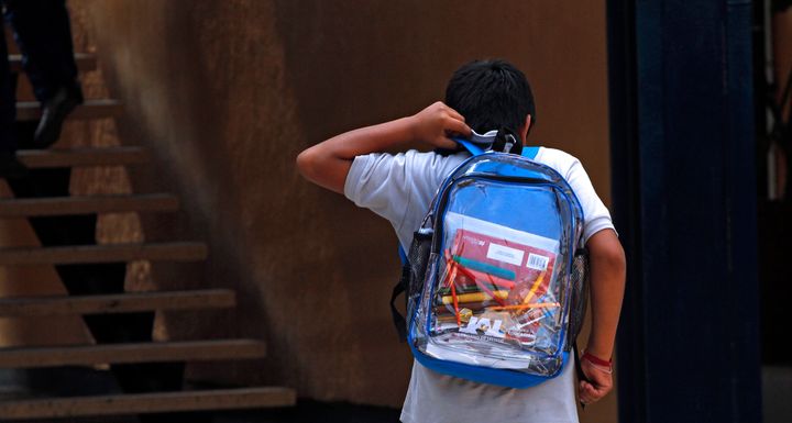 A student wearing a transparent backpack. 