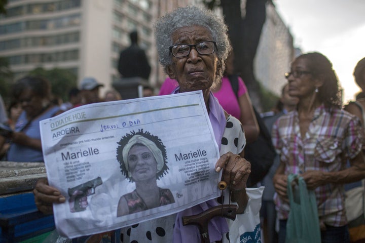 A protester in Rio de Janeiro carries a newspaper featuring Brazilian councilwoman and activist Marielle Franco on March 20, 2018, following Franco's killing on March 14.