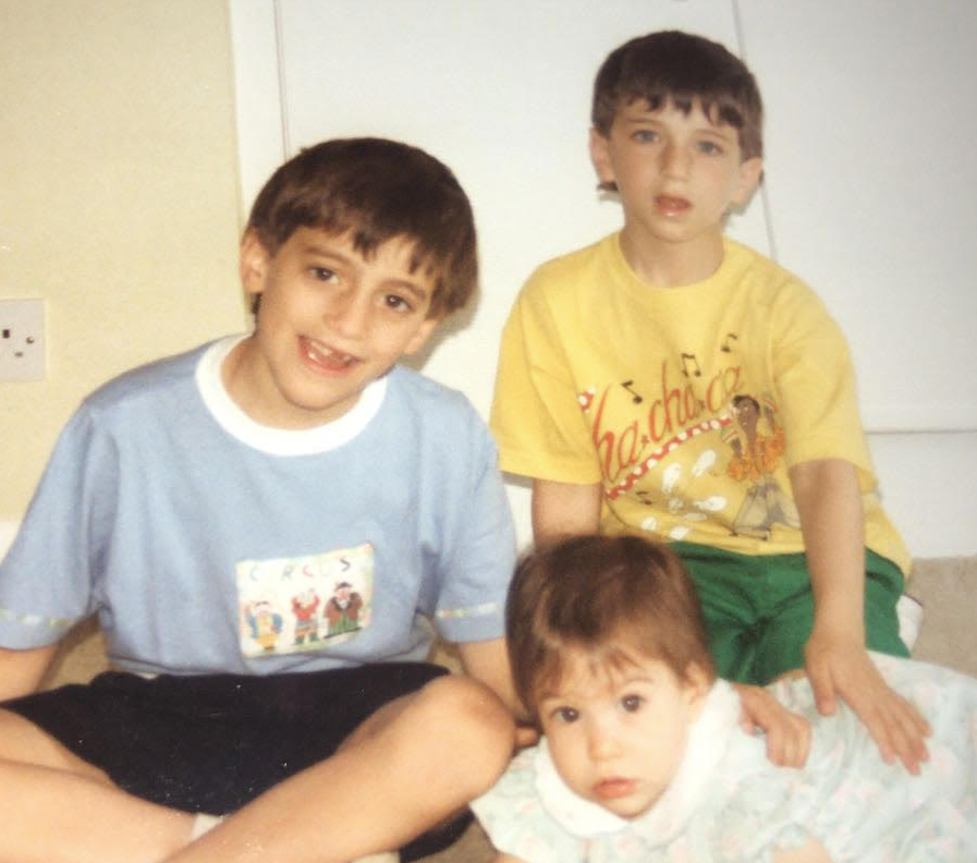 Then: Robert (L), Darren (in yellow) and their sister Emma in 1990.