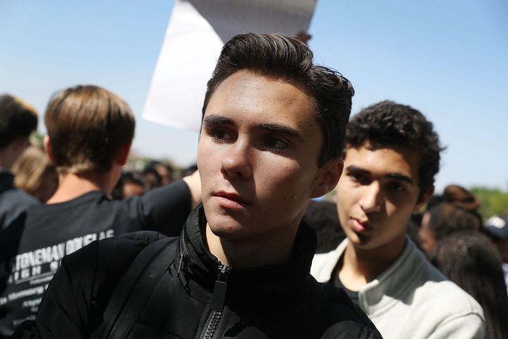 David Hogg and other students from Marjory Stoneman Douglas High School walk out of class on March 14, 2018 to honor the memories of 17 classmates and teachers killed during a mass shooting at the school.
