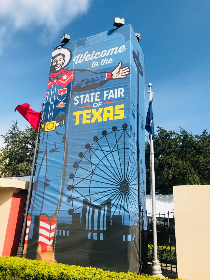 A sign featuring Big Tex greets visitors to Fair Park in Dallas. South Dallas.