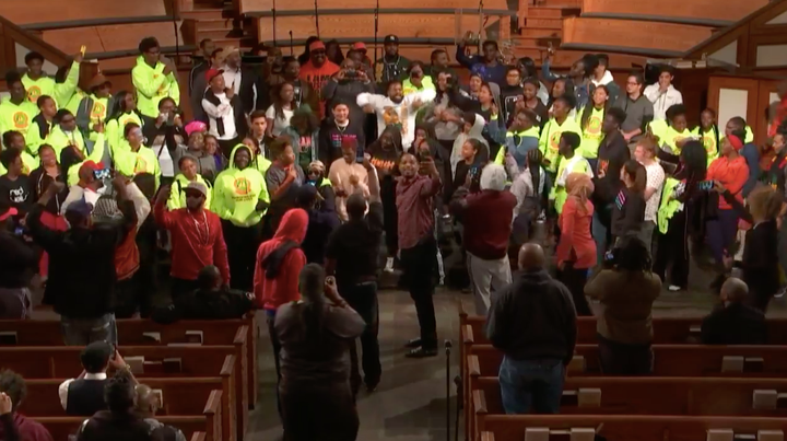 Students and anti-gun violence activists sing together at the end of the event.