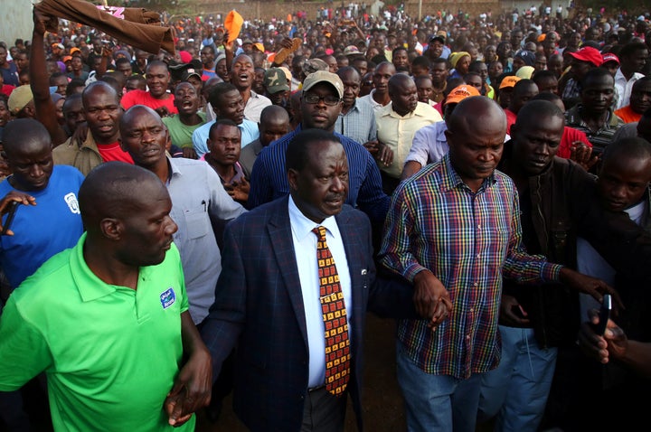 Kenyan opposition leader Raila Odinga (center) lost three successive elections to Uhuru Kenyatta, who had hired Cambridge Analytica.