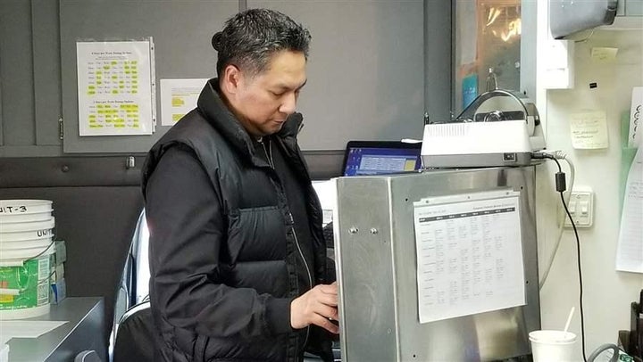 Julius Tiangson, a registered nurse, dosing a patient in a methadone van operated by Evergreen Treatment Services in Seattle.