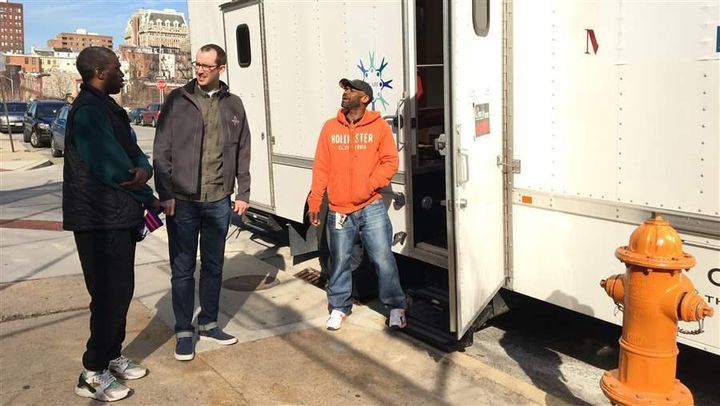 Terrance Washington, who is receiving medication-assisted treatment for heroin addiction, talks to nurse Stephen Wright and driver Larry Dawkins outside a treatment van parked at Baltimore’s central jail. As the opioid epidemic grows, treatment programs are planning to extend services to more people by using mobile units.