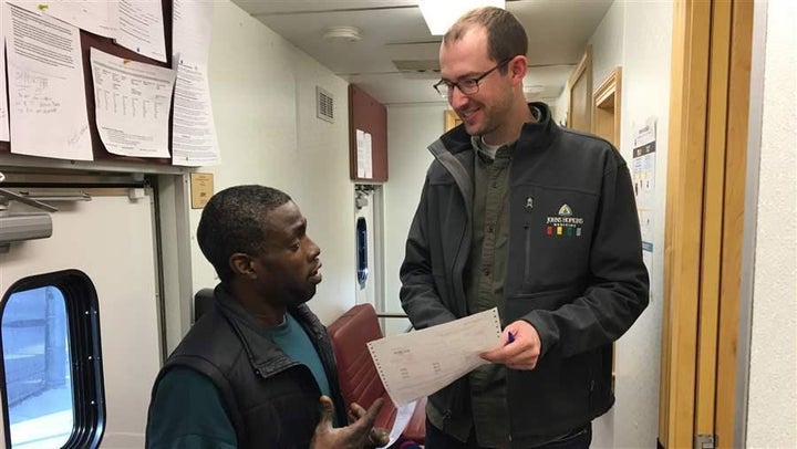 Terrance Washington reviews his treatment schedule with nurse Stephen Wright in a treatment van parked at Baltimore’s central jail.