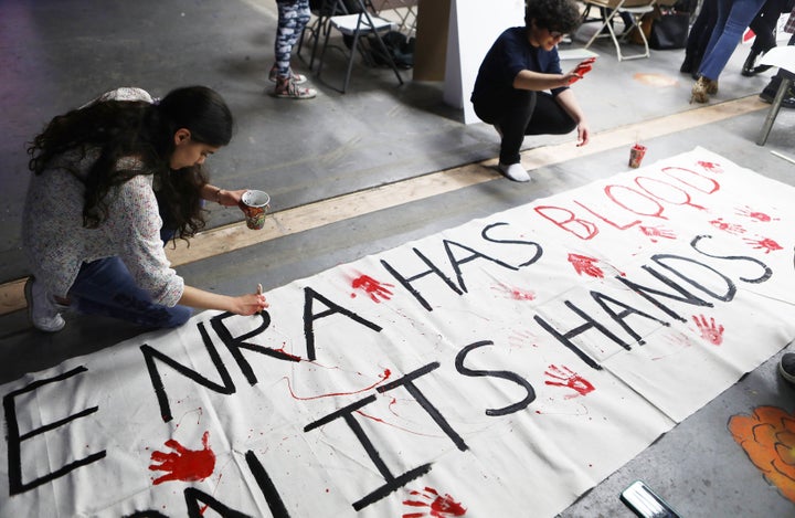 Young activists paint signs to be carried at the March For Our Lives in Los Angeles.