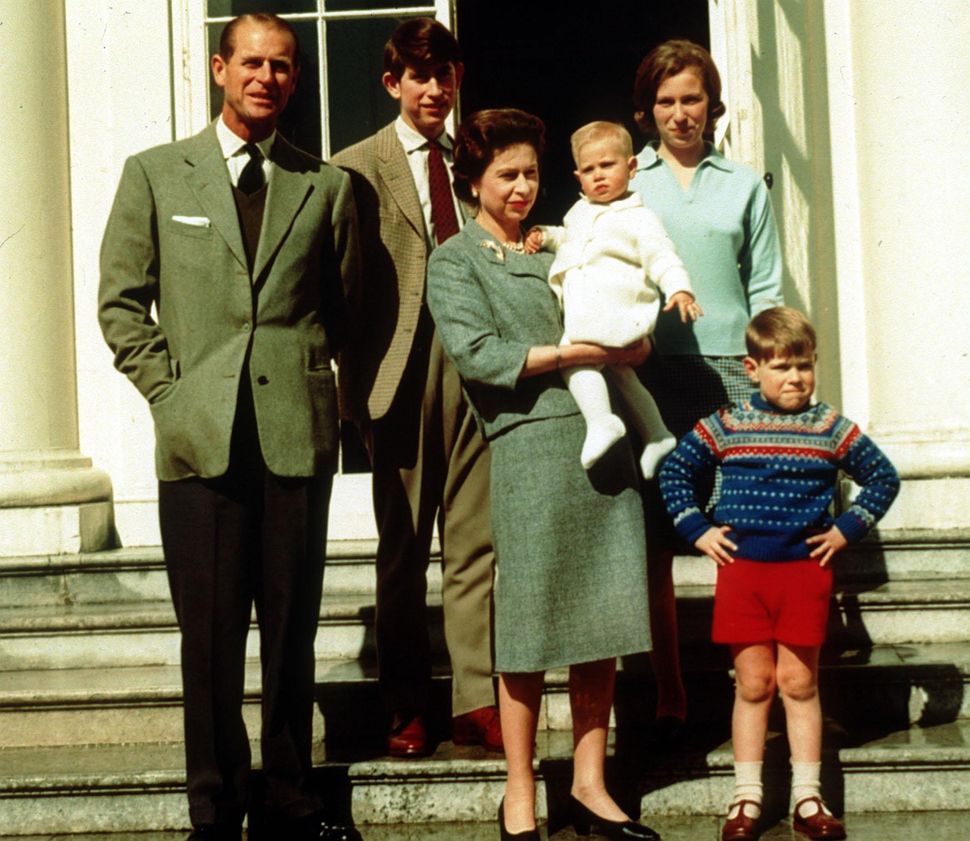 Prince Charles stood at the back of a family portrait alongside his parents, brothers and sister.