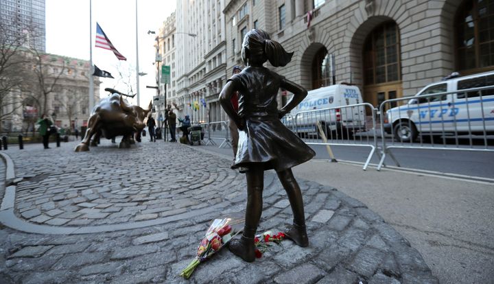 The "fearless girl" statue faces the bronze bull statue near Wall Street in New York, New York. 