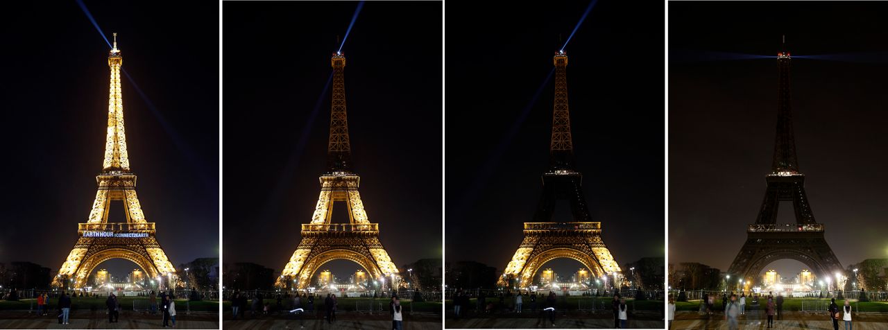 The Eiffel Tower is seen submerging into darkness as part of the Earth Hour switch-off on Saturday.