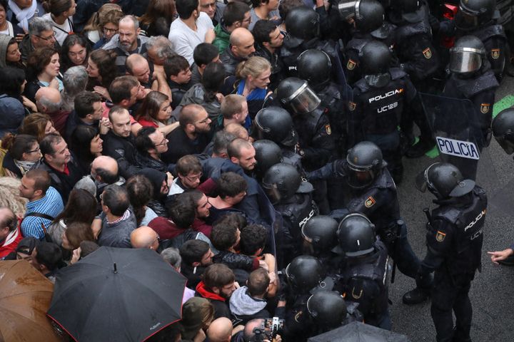 October 1, 2017: Riot police face off with demonstrators outside a polling station for the banned independence referendum in Barcelona