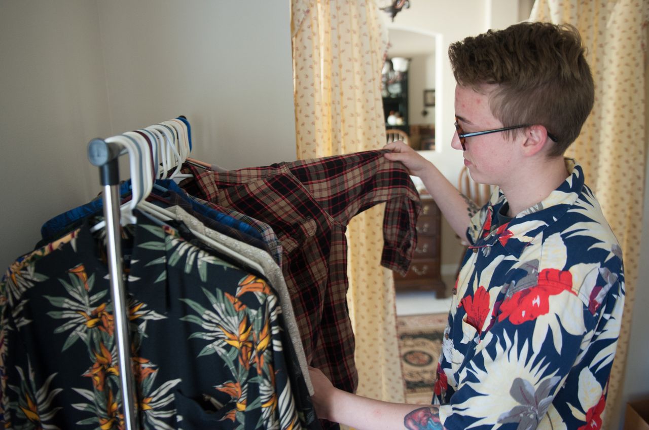 Preston Curts looks through clothes at his home in Ocala, Florida.