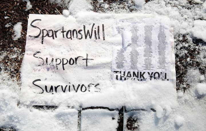 A snow-covered sign on the campus of Michigan State University shows support for the survivors of Larry Nassar's abuse.