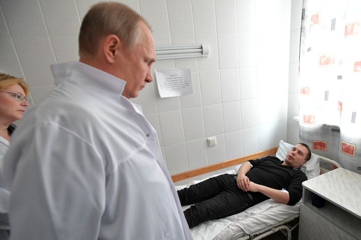 Russian President Vladimir Putin meets with victims injured in the blaze at a hospital 