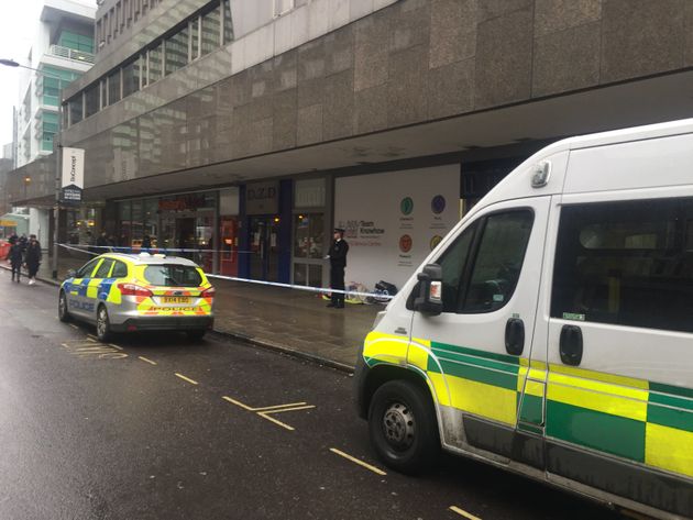 Police guard the body of a rough sleeper who died on Tottenham Court Road overnight on Tuesday