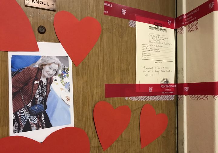 Red tape police seals and a photograph are seen on the front door of the apartment of Mireille Knoll in Paris