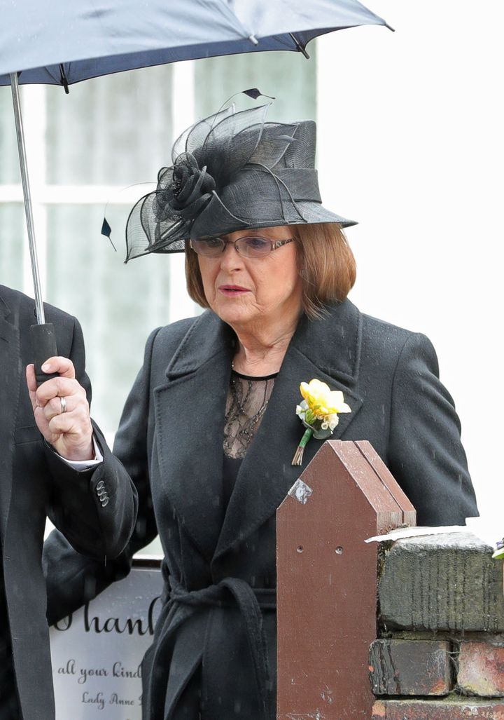Sir Ken's wife, Anne, leaves their home in Knotty Ash ahead of his funeral at Liverpool Cathedral.