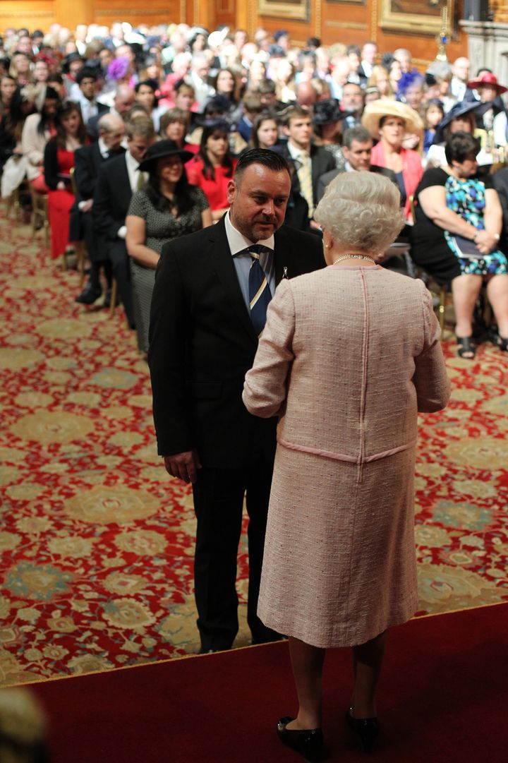 Nick receiving his MBE in 2014