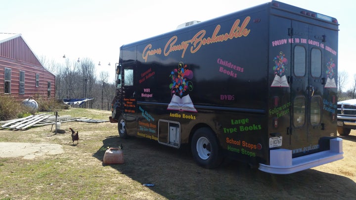 A hen struts near a bookmobile on an Amish farm in western Kentucky, one of the many rural stops on the library’s route.