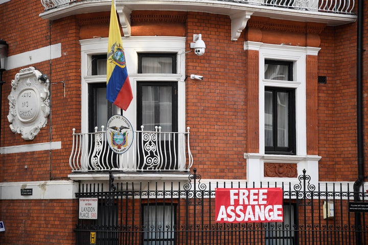 A sign is pinned to the railings outside the Ecuadorean embassy in central London as Wikileaks founder Julian Assange goes to court again to avoid arrest in London in January.