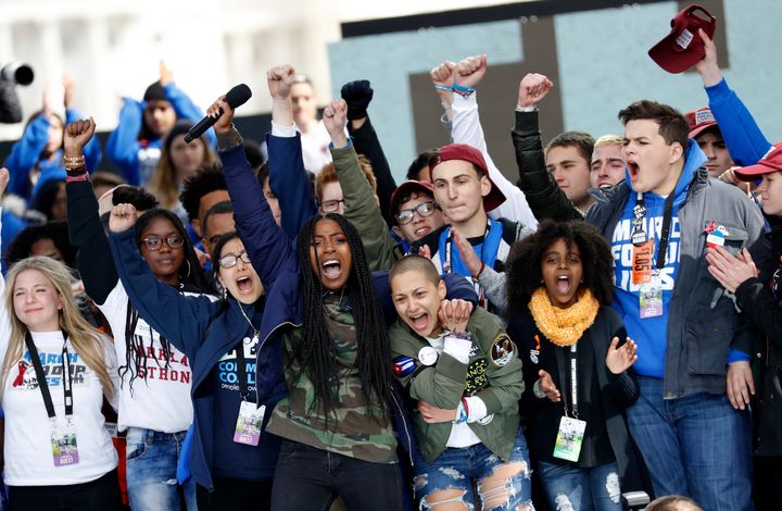 Shooting survivors Tyra Hemans and Emma Gonzalez lead cheers with 11-year-old Naomi Wadler of Alexandria, Virginia, at the conclusion of the March for Our Lives in Washington on March 24, 2018.