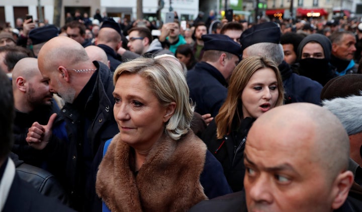 Marine Le Pen, leader of the France's far-right party, attends the march in spite of calls for her to not come.