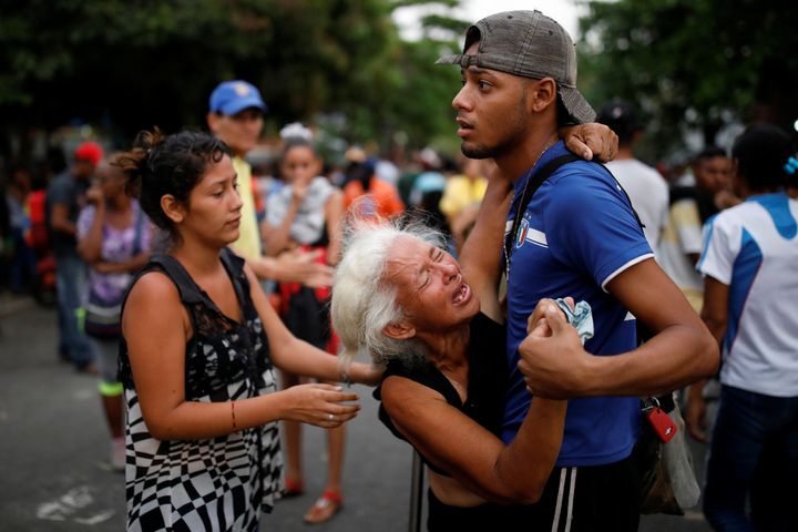 Relatives of inmates held at the General Command of the Carabobo Police react as they wait outside the prison, where a fire occurred in the cells area, according to local media, in Valencia, Venezuela.