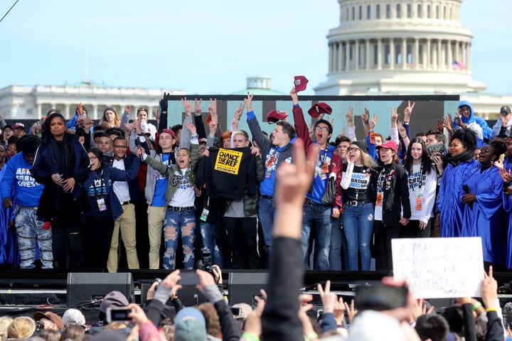 Marjory Stoneman Douglas students wave to the crowd during the March for Our Lives to demand stricter gun control laws on March 24, 2018 in Washington.