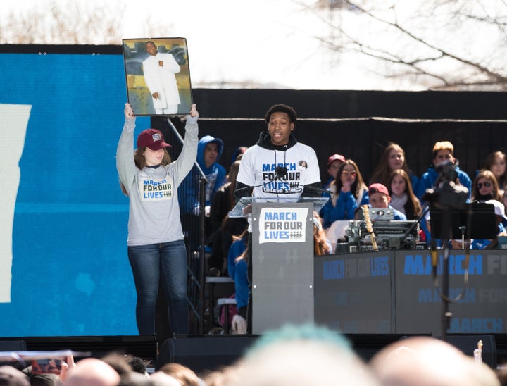 Trevon Bosley speaks during March For Our Lives on March 24, 2018 in Washington. Bosley's brother Terrell, in the photo on the left, was shot and killed in 2006 while leaving church.