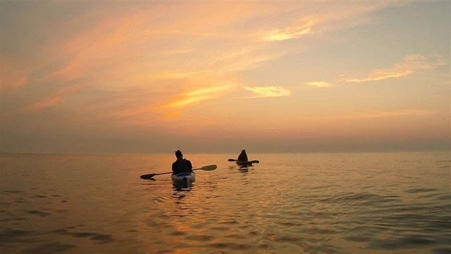 Kayakers paddle on Lake Michigan. A proposed Foxconn electronics plant in Wisconsin would drain 7 million gallons a day from