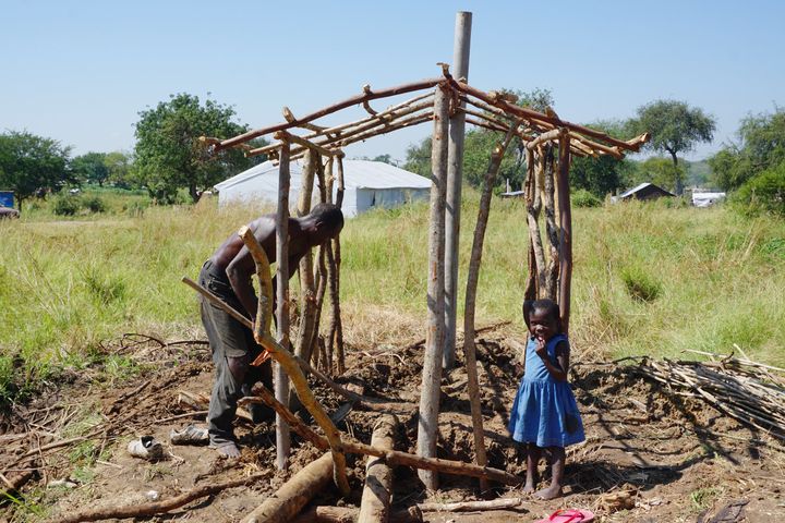 A South Sudanese refugee digs a pit latrine for his family in the Bidi Bidi refugee camp.