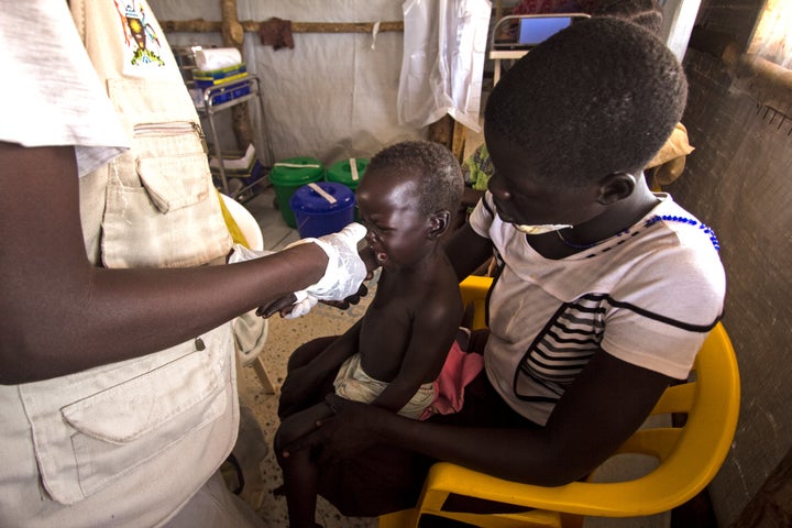 A baby is treated for malaria at a makeshift clinic in the Palabek refugee settlement in northern Uganda.