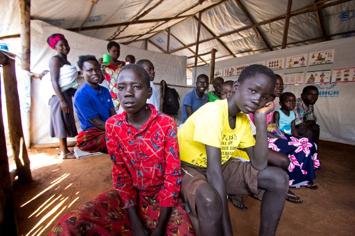 People wait at a clinic in the Palabek refugee settlement.