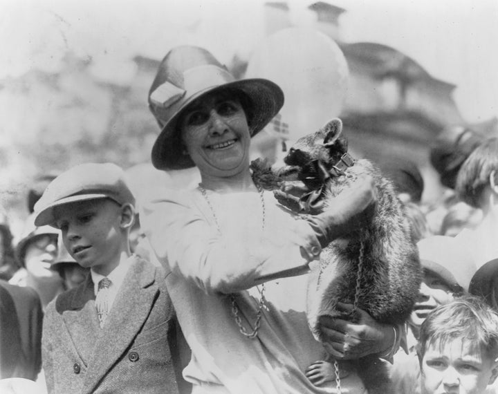 First Lady Grace Coolidge with her pet raccoon at the White House Easter Egg Roll in 1927.