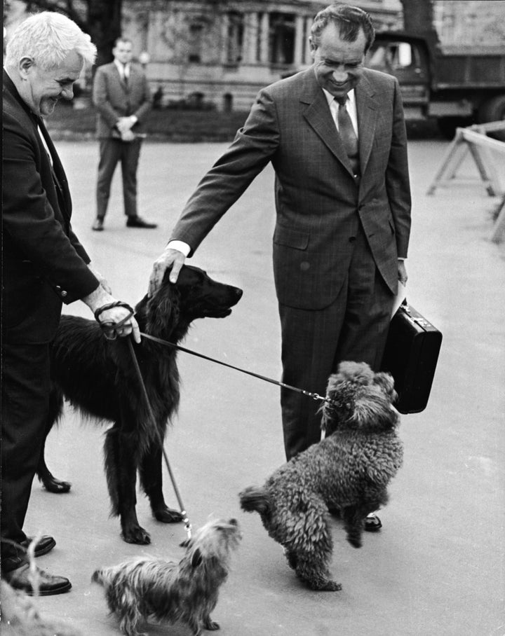 Nixon greets his dogs outside the White House in 1970.