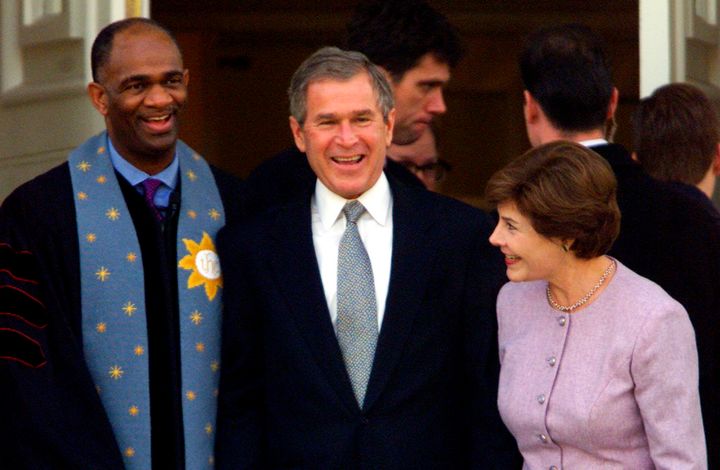 George W. Bush stands with his wife Laura and Rev. Kirbyjon H. Caldwell after services at Tarrytown United Methodist Church in Austin, Texas, on Dec. 14, 2000. Caldwell has long been a spiritual adviser to Bush.