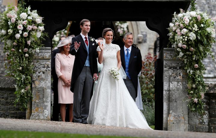 James Matthews poses last spring with his new bride, Pippa Middleton, as James' father, David Matthews (right), looks on.
