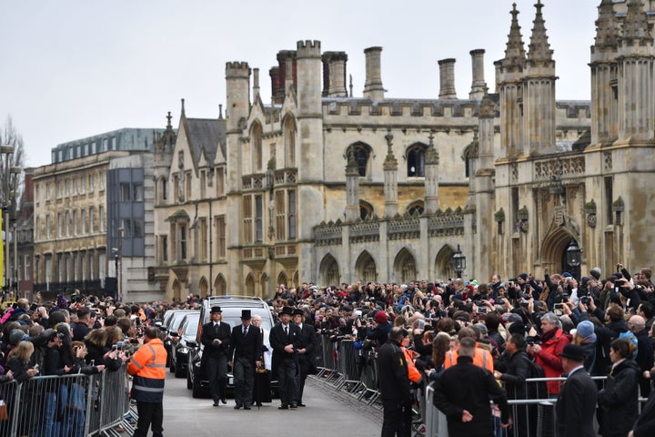 Crowds watch at the cortege approaches the church