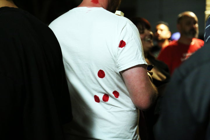 A protester wears a shirt marked with red spots where Stephon Clark was shot by Sacramento police.